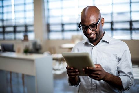 Professional Man Using Tablet in Modern Office Environment