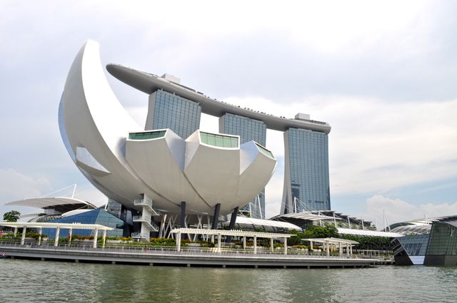 Marina Bay Sands and the ArtScience Museum in Singapore showcasing modern architecture and iconic design on the waterfront. Useful for travel blogs, tourism advertisements, urban living articles, architecture magazines, and promotional material for Singapore.