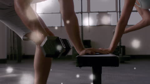 Diverse Individuals Exercising with Dumbbells in Gym