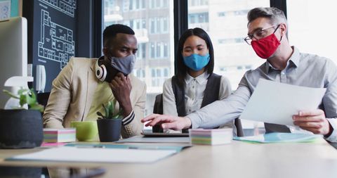 Diverse Team Collaborating in Office with Safety Protocols - Download Free Stock Images Pikwizard.com