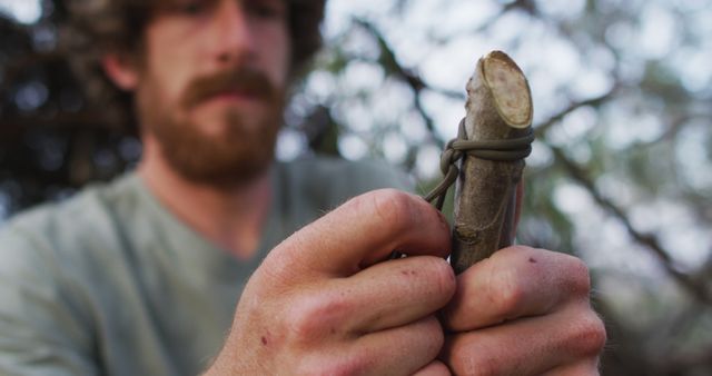 Survivalist Wrapping Cord Around Stick for Wilderness Skills - Download Free Stock Images Pikwizard.com