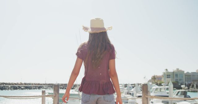 Young Woman in Summer Hat Enjoying Marina View - Download Free Stock Images Pikwizard.com