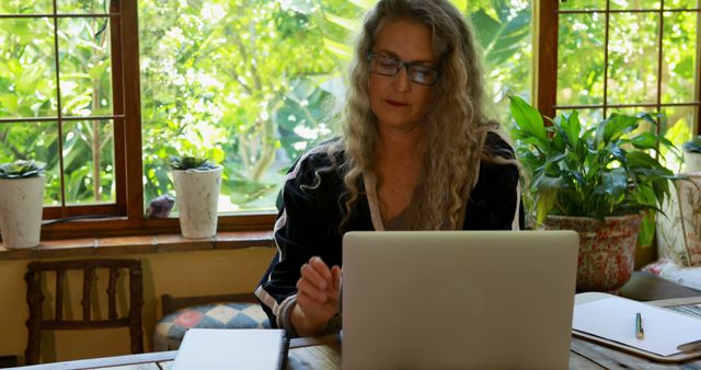 Senior Woman Working on Laptop in Bright, Green Home Office - Download Free Stock Images Pikwizard.com