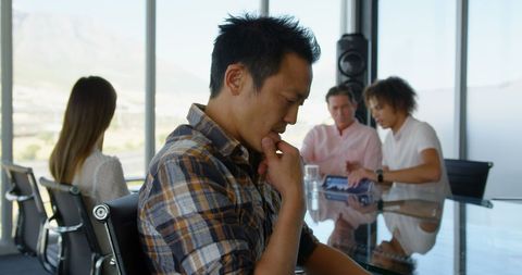 Thoughtful Executive in Modern Office Conference Room