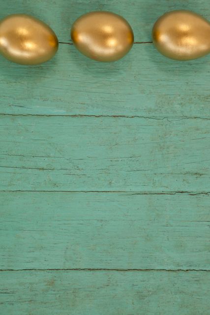 Golden Easter Eggs on Turquoise Wooden Background - Download Free Stock Photos Pikwizard.com