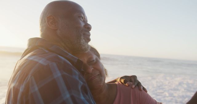 Mature couple embracing on a beach at sunset - Download Free Stock Images Pikwizard.com