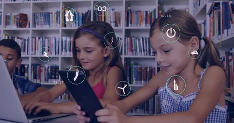 Children learning on tablet with augmented reality overlays in library collaborative learning