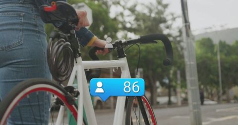 Woman Standing Cityside with Bicycle and Social Media Icon
