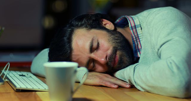 Exhausted Young Man Sleeping at Desk Late at Night - Download Free Stock Images Pikwizard.com