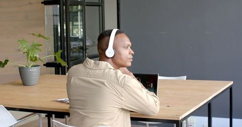 Professional in Office Wearing Headphones for Focus