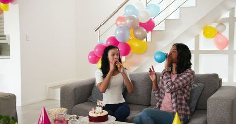 Mother and Daughter Preparing for Birthday Celebration with Balloons