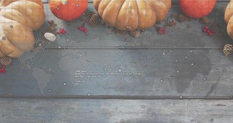 Autumn harvest flatlay showing pumpkins and gourds on blue wood halftone world map overlay