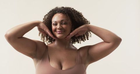 Confident Plus Size Woman Smiling in Studio