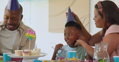Happy Boy Celebrating Birthday with Parents at Home