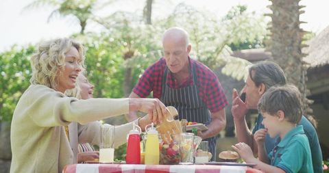 Caucasian family enjoying backyard barbecue gathering