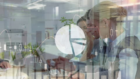 A diverse team of business professionals in an office collaborating while a complex digital interface of charts and graphs overlays their work space. Perfect for illustrating concepts related to business analytics, teamwork, global connectivity, and data-driven strategy planning.