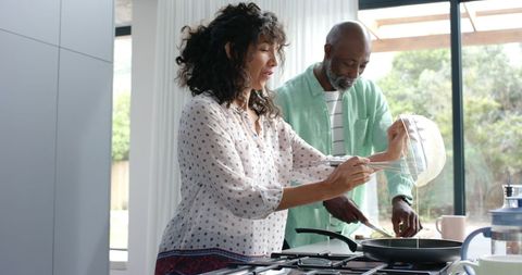 Happy Couple Cooking Together at Home Cooking Breakfast
