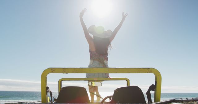 Happy caucasian woman sitting on beach buggy by the sea waving hands - Download Free Stock Photos Pikwizard.com