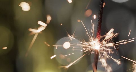 Close-up of Sparklers Against Blurred Festive Lights - Download Free Stock Images Pikwizard.com