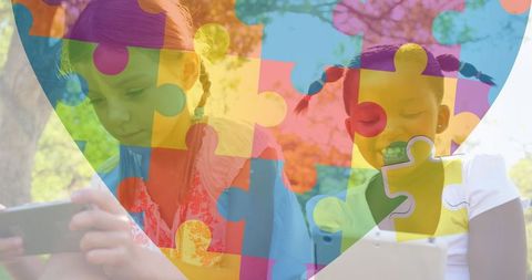 Children with Tablets and Puzzle Heart Graphic