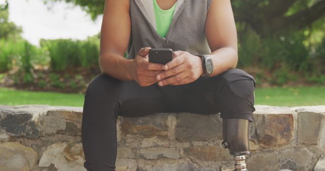 Person with Prosthetic Leg Using Smartphone Outdoors - Download Free Stock Images Pikwizard.com