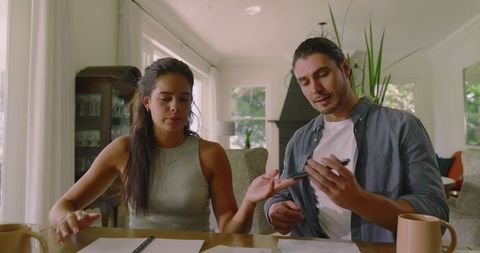 Couple Collaborating on Wedding Plans in Cozy Living Room