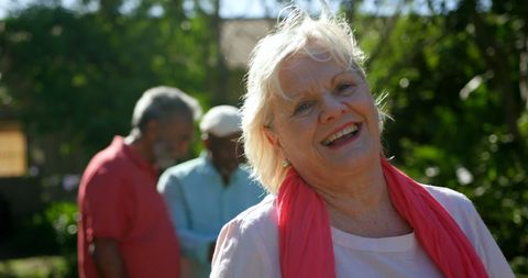 Smiling Senior Woman Enjoying Nursing Home Garden