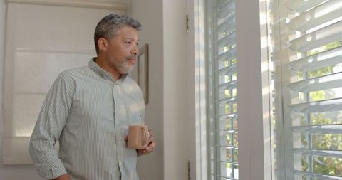 Senior Man Contemplating Morning Views with Coffee