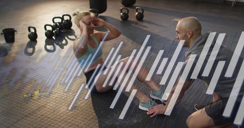 Personal trainer coaching woman doing crunches with kettlebells and fitness data overlay