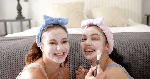 Young friends enjoying skincare routine at home