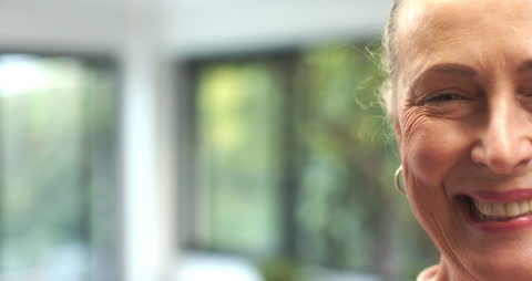 Joyful Senior Woman Smiling in Bright Room