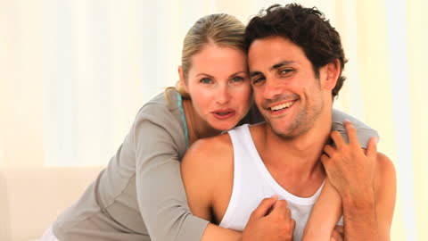 Young Couple Embracing with Joyful Expressions