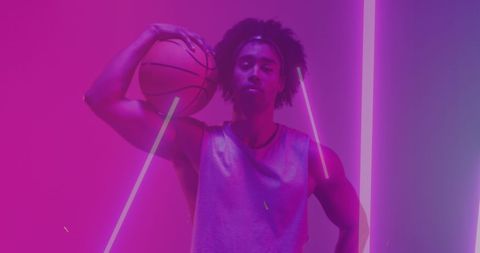 Basketball Player in Neon Lighting Holding Ball