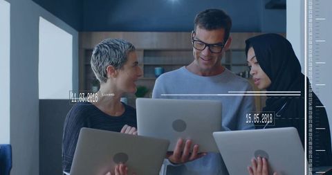 Creative Team Collaborating in Modern Office with Laptops