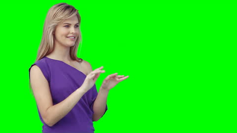 Woman Interacting with Virtual Technology on Green Backdrop