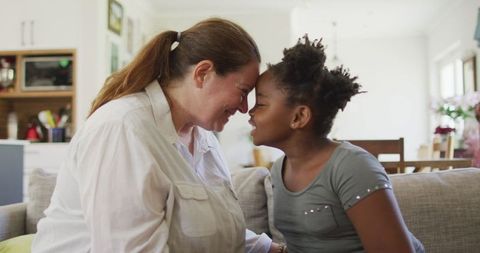 Loving Mother and Daughter Bonding Moment on Sofa