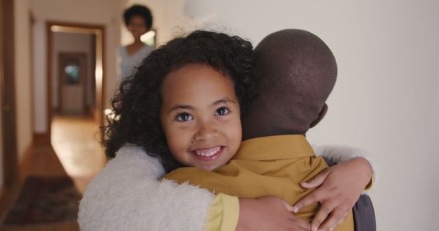 Child embracing parent with joy and affection in a cozy home setting. The image captures the love and bond within a family. Ideal for use in family-oriented content, parenting blogs, advertisements promoting family values, or chronicles showcasing the warmth and closeness of family relationships.