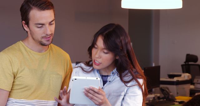 Two Young Professionals Collaborating on a Digital Tablet - Download Free Stock Images Pikwizard.com