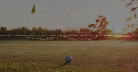 Golf Ball on Green with Audio Waveform Overlay at Sunset