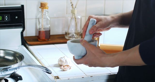 Man Using Mortar and Pestle in Kitchen for Food Preparation - Download Free Stock Images Pikwizard.com