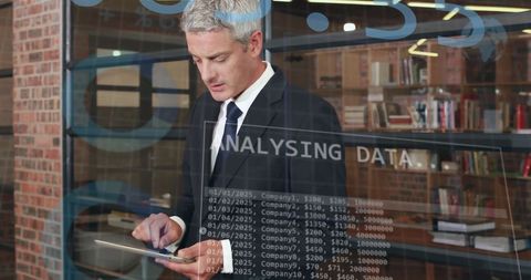 Businessman engaged in digital data analysis interface