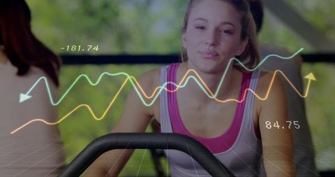 Pedaling woman on stationary bike with holographic fitness data overlays and analytics