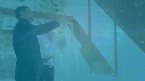 Diverse Businessmen Engaged in Office Discussion with Golden Confetti