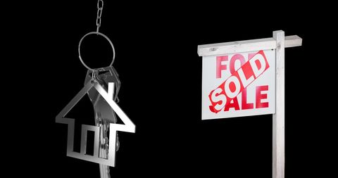 Sold Real Estate Sign with House Key on Black Background