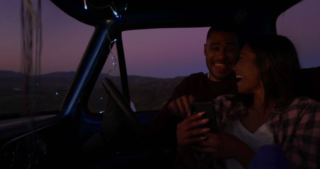 Couple laughing in car during sunset road trip - Download Free Stock Images Pikwizard.com