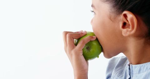 Child Eating Green Apple Promoting Healthy Habits