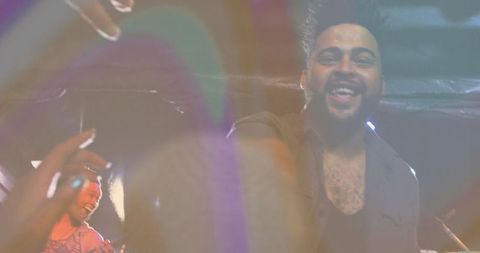 Energetic Nightclub Performance with Hazy Lighting Atmosphere