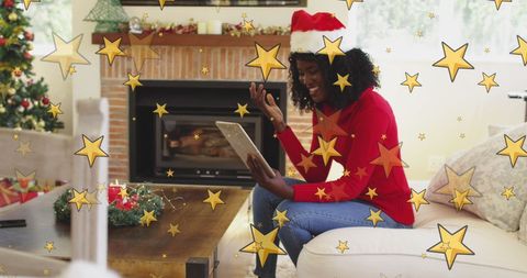 Festive African American Woman Video Calling by Fireplace
