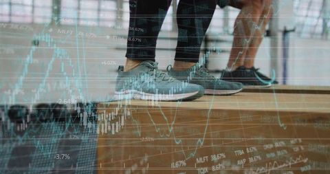 Balancing partners on plyo box wearing sneakers with stock market overlay for fitness
