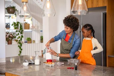 Mother and Daughter Baking Together in Modern Kitchen Setting